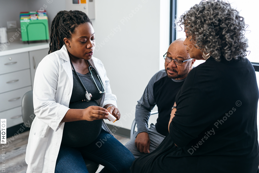 African American female doctor consults with senior medical patients about prescription drugs