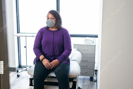Black senior woman waiting in medical exam room