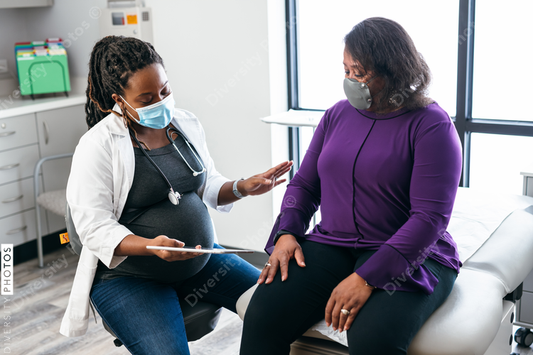 Black doctor consulting with senior patient about lab results, connection 