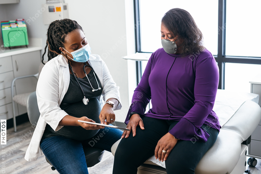 Black doctor consulting with senior patient about lab results, connection 