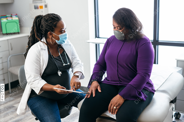 Black doctor consulting with senior patient about lab results, connection 