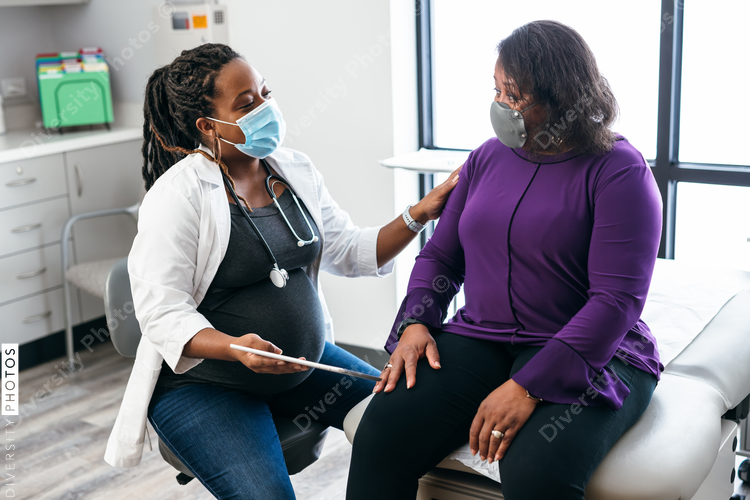 Black doctor consulting with senior patient about lab results, connection 