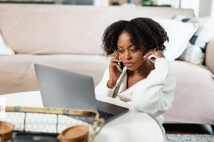 Woman working from home, comfortably on floor in family room, video chat