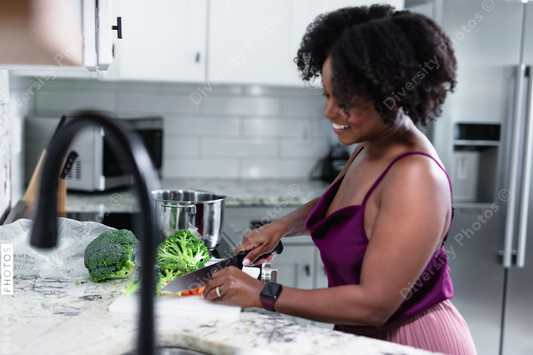 Black woman cooking at home, healthy vegetables 
