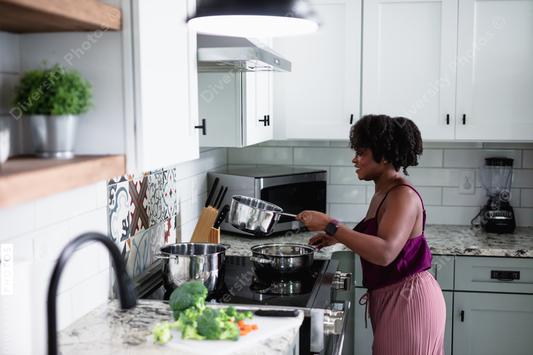 Black woman cooking at home, healthy vegetables 
