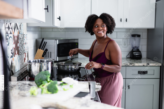Black woman cooking in kitchen