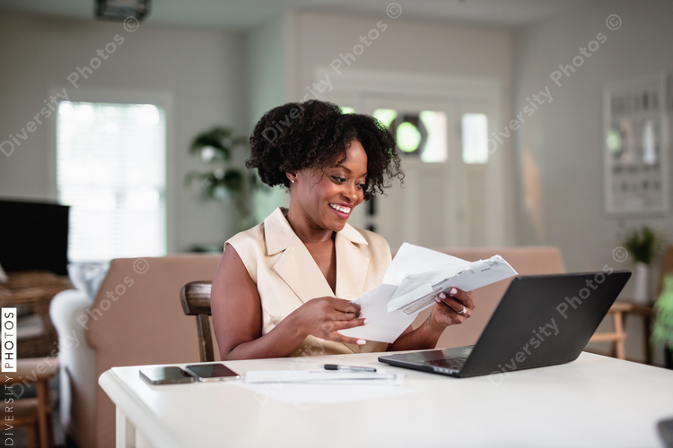Black woman focused and paying bills, professional 