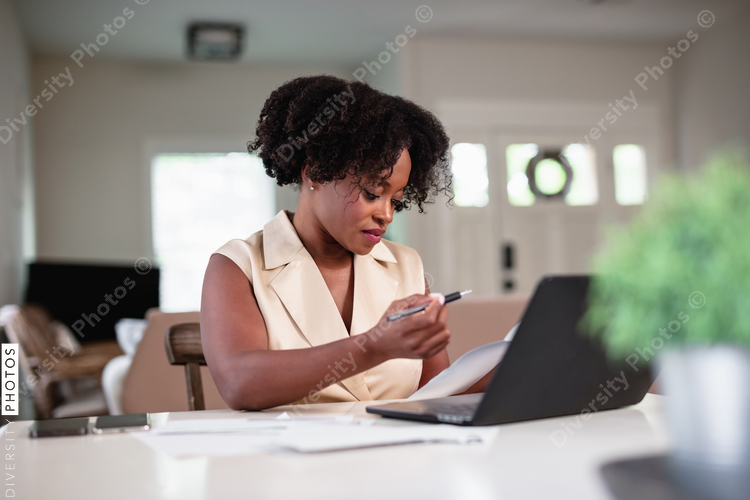Black woman focused and paying bills, professional 