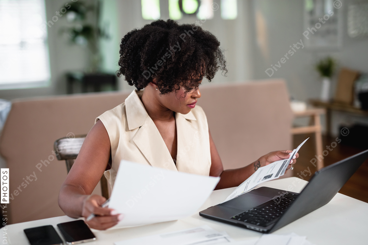 Black woman focused and paying bills, professional 