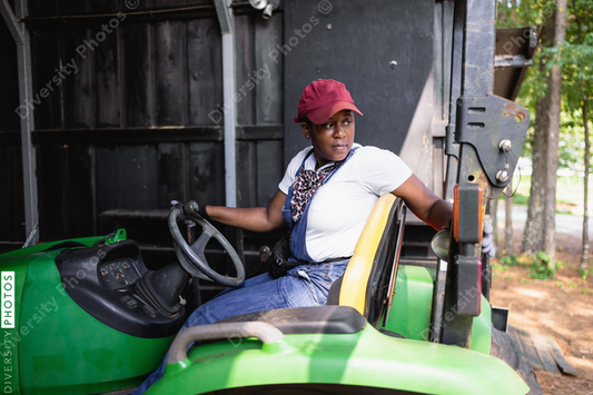 African American Female farmer on tractor