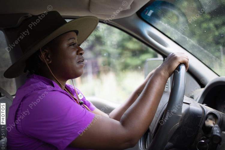 Female farmer in hat driving car