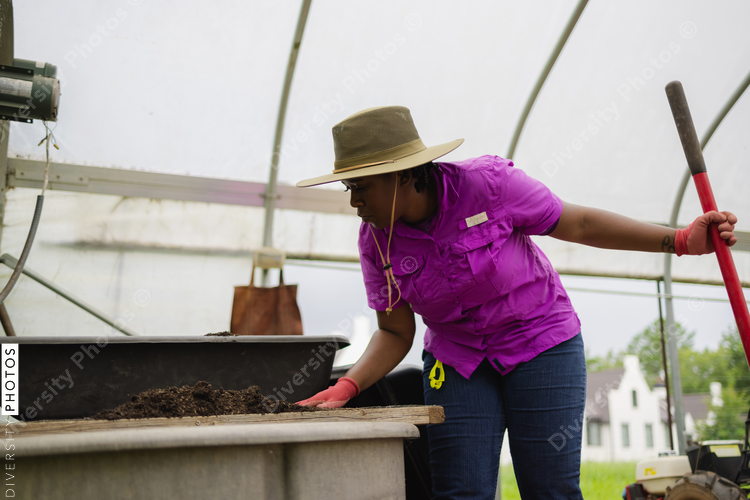 Female farmer working in greenhouse