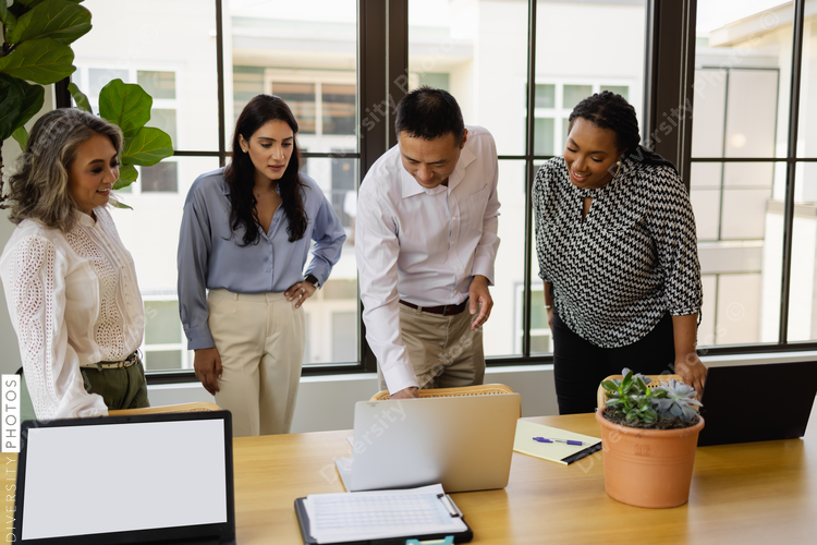 Diverse business people meeting at laptop in office