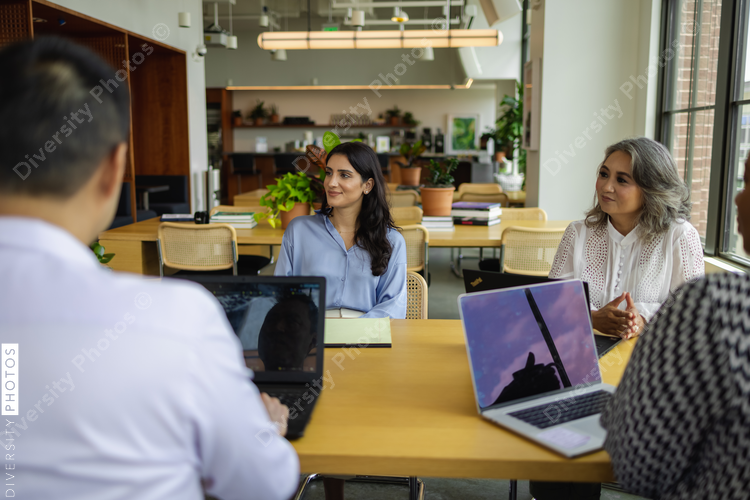 Middle Eastern business leader, having discussions with team, female