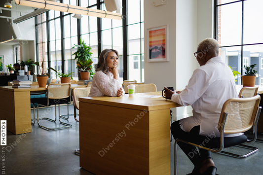 Black and Asian colleagues having coffee and tea, during break