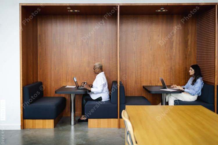Diverse business people working in modern office booths
