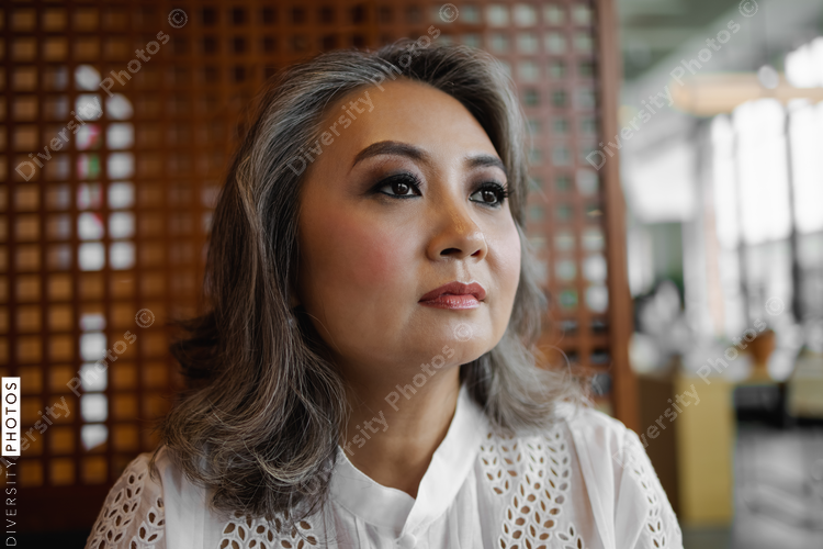 Portrait of mature Chinese woman, business, visionary with copy-space 
