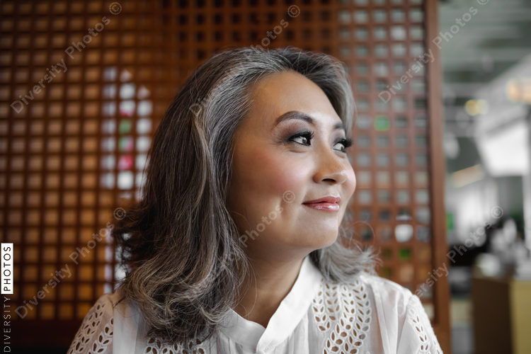 Portrait of mature Chinese woman, business, visionary with copy-space 