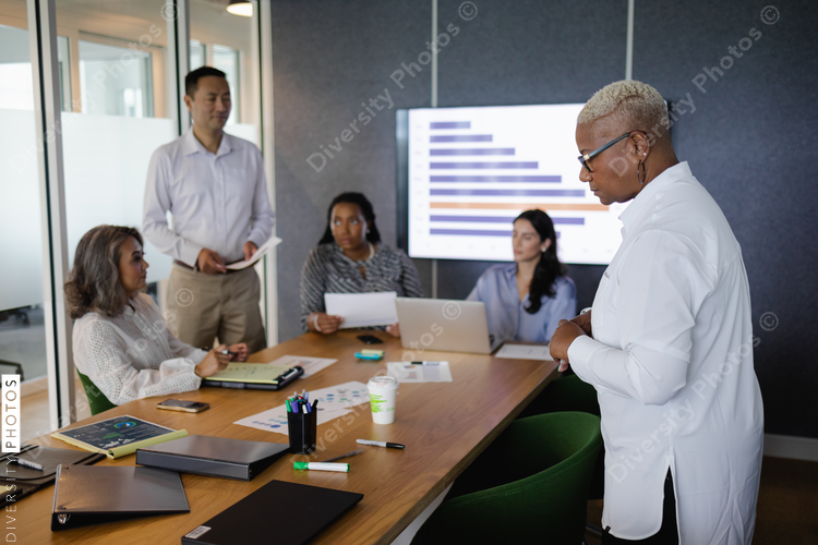 Diverse business team brainstorming and collaborates in conference room, senior Black woman leadership
