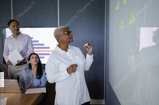 Diverse business team brainstorming and collaborates in conference room, senior Black woman leadership