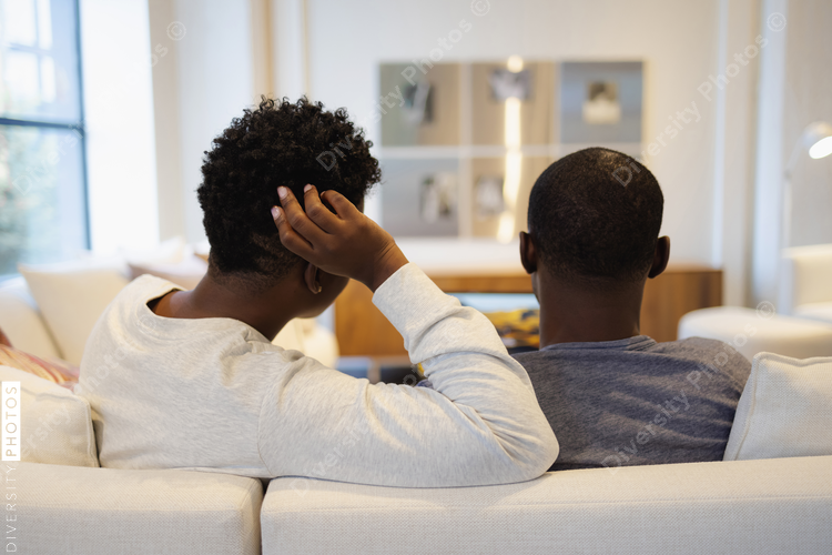 Rear view of Black couple sitting on sofa
