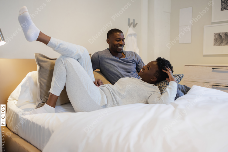 Smiling couple lying in bed