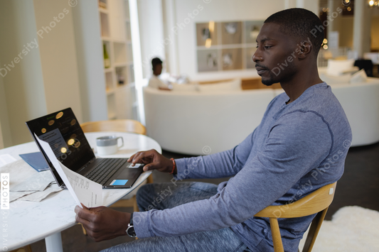 Black Man working on laptop at home