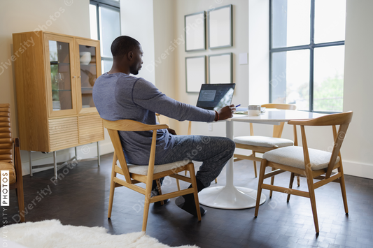 African American Man and woman working on laptop at home