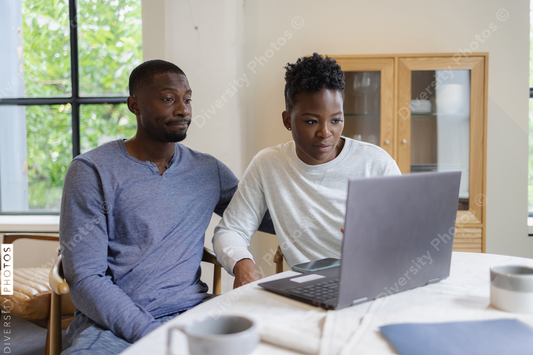Black Couple using laptop at home