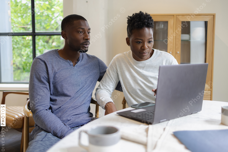 Couple using laptop at home