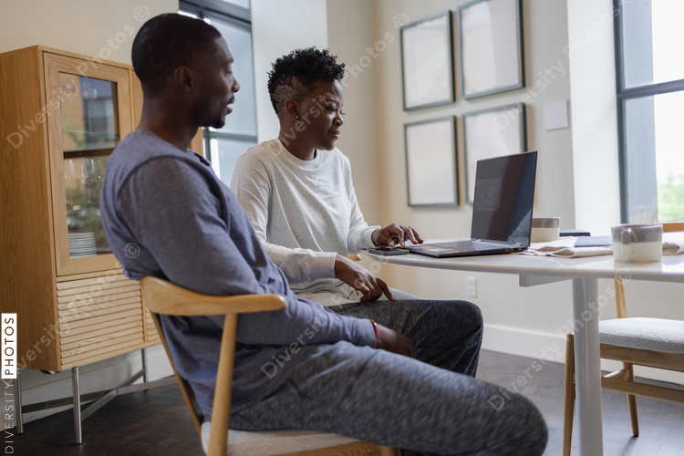 Couple using laptop at home