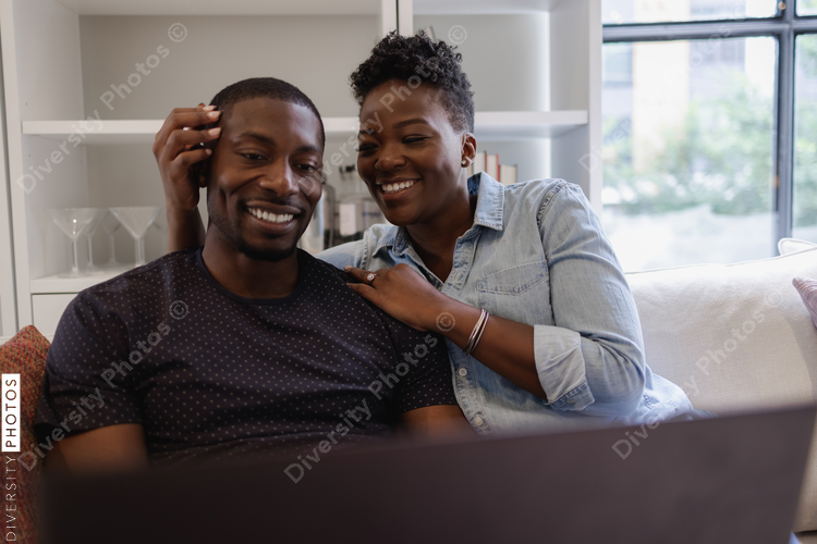Couple sitting on sofa and smiling