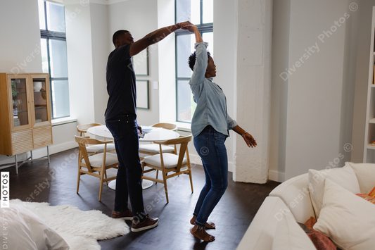 African American Couple dancing in living room