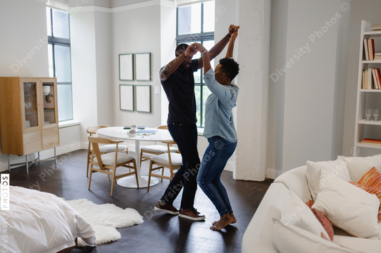 Black Couple dancing in living room