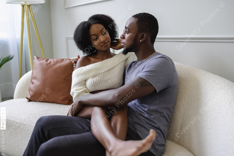 Couple sitting on sofa and embracing