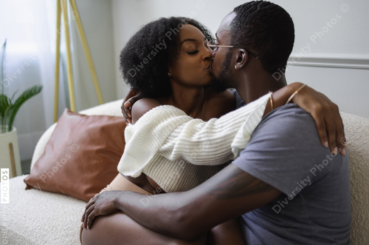 Black Couple kissing on sofa