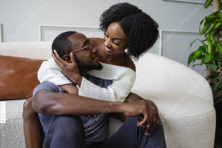 Smiling couple embracing in living room
