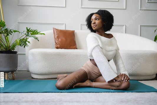 Young woman stretching in living room