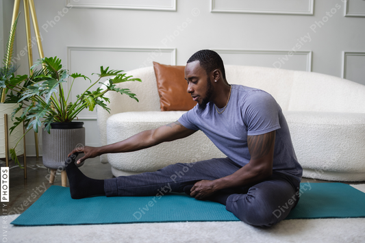Young man stretching in living room