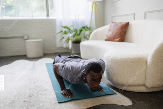 Young man doing push ups in living room