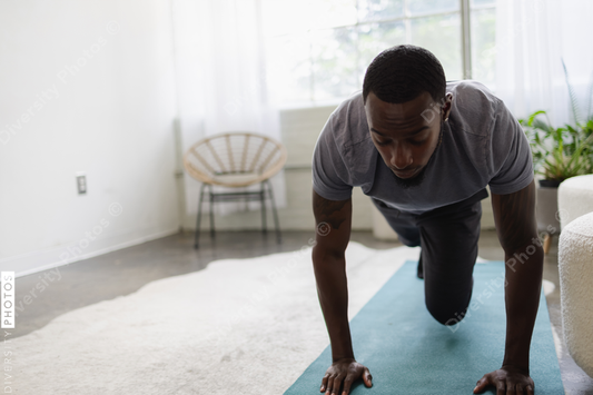 Young man exercising in living room