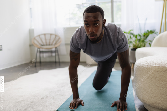 Young man exercising in living room