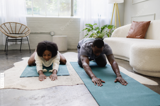 Young couple stretching in living room