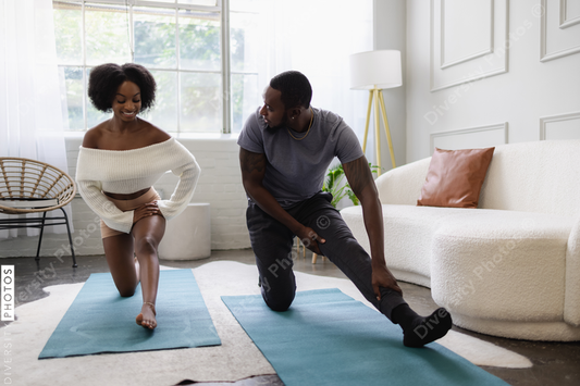 Young couple stretching in living room