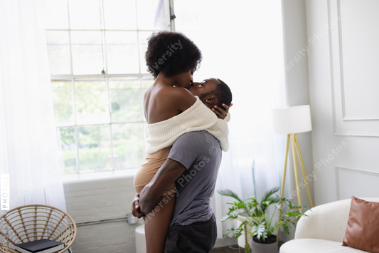 Young couple kissing in living room