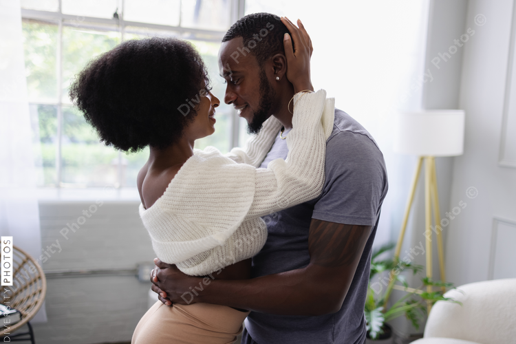 Young couple hugging at home