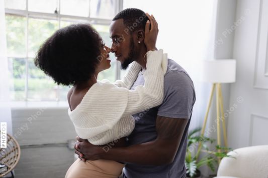Young couple hugging at home