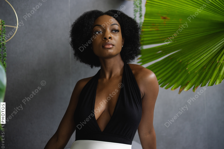 Elegant young woman among plants