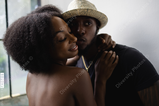 Young African American couple kissing and embracing and in love
