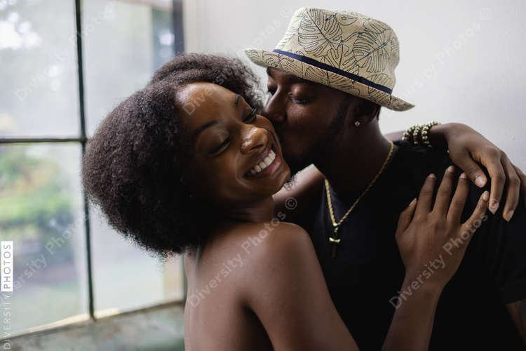 Boyfriend giving girlfriend kiss, happy African American couple